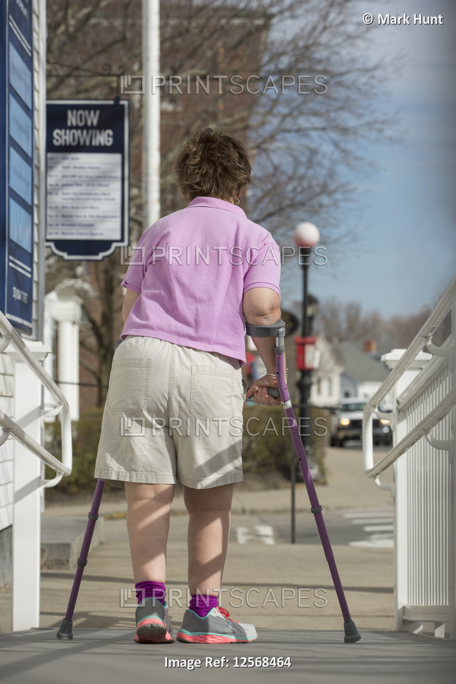 Woman with Cerebral Palsy walking down an accessible ramp