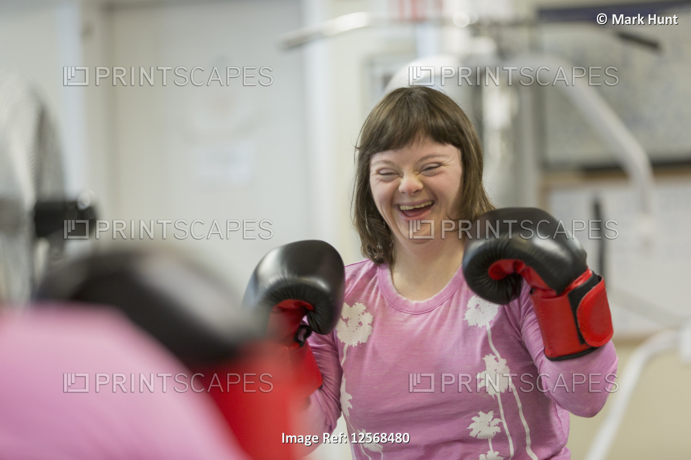 Woman with Down Syndrome working out with boxing gloves