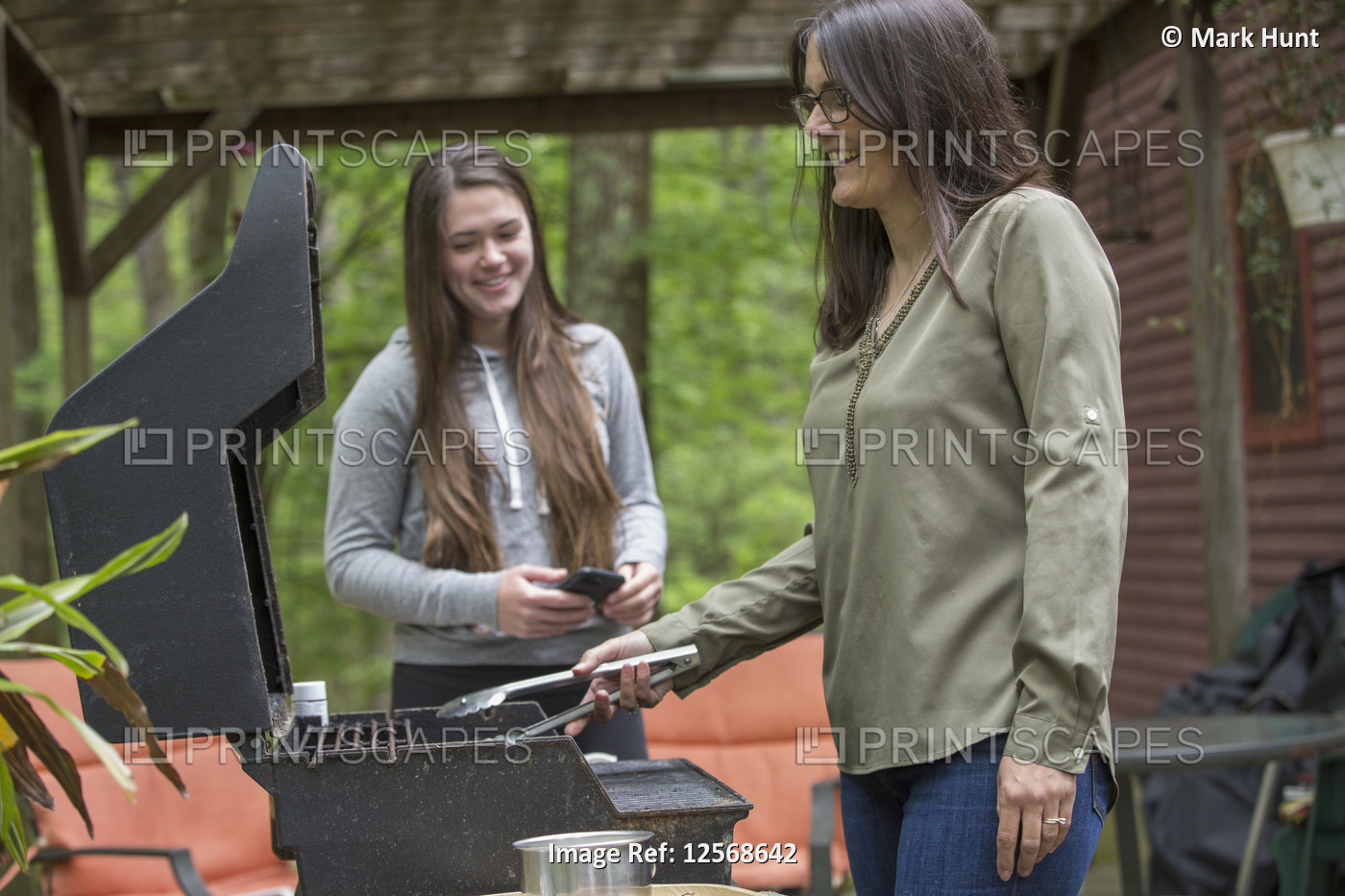 Woman with Multiple Sclerosis cooking outdoors with her daughter