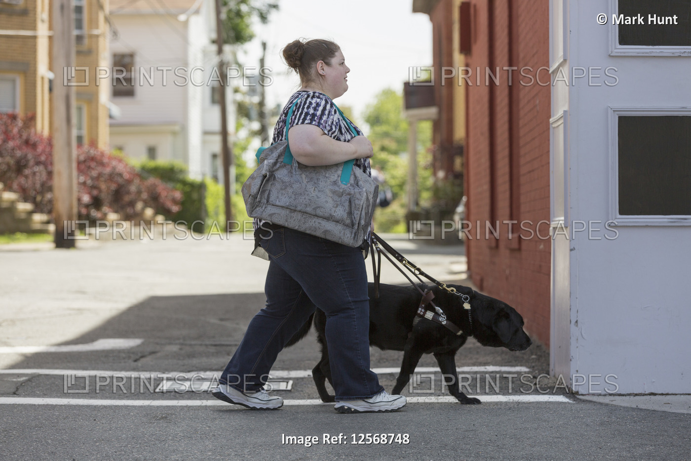 Woman with Visual Impairment crossing the street with her service dog
