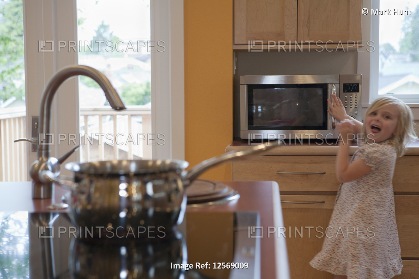 Girl using a microwave in a disability accessible home