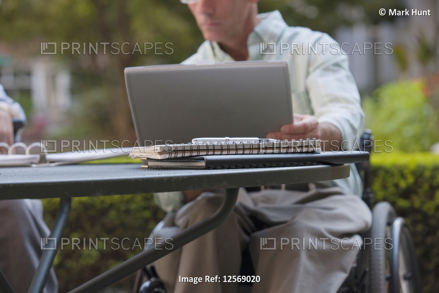 Businessman with spinal cord injury working on a laptop