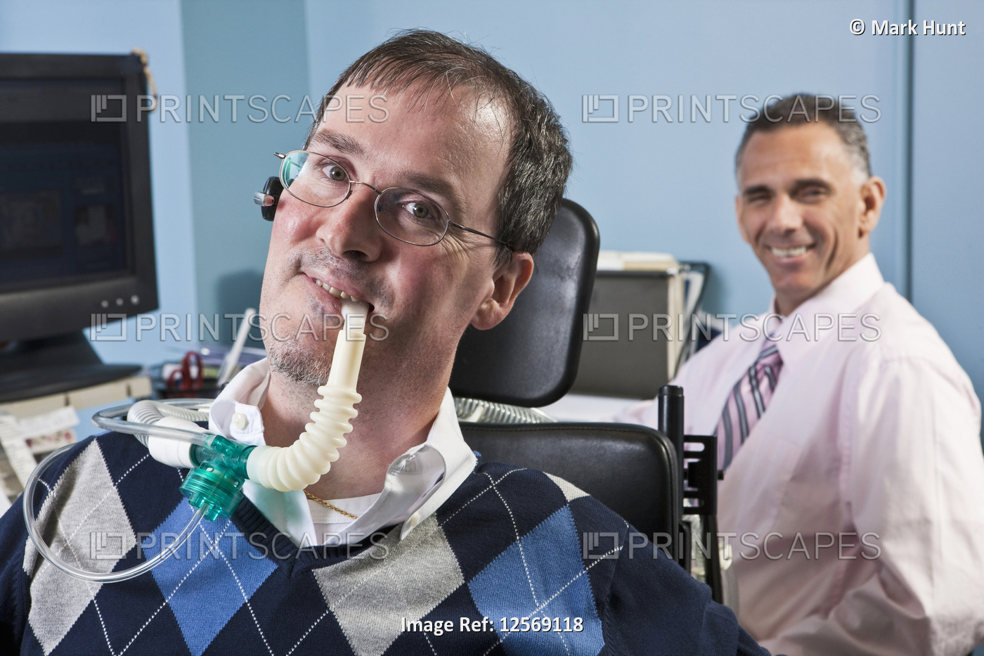 Businessman with Duchenne muscular dystrophy using a breathing ventilator and ...