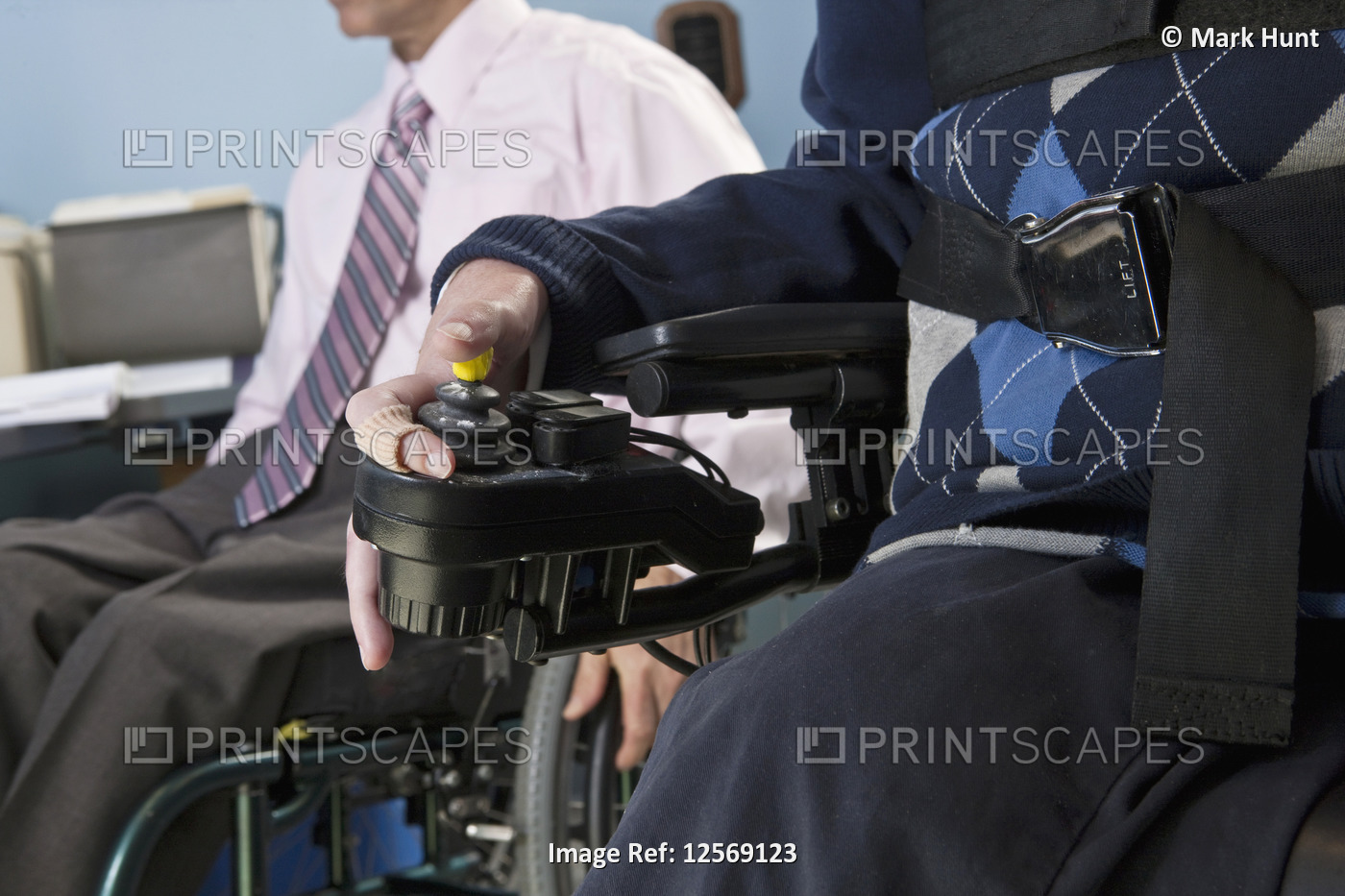 Businessman with Duchenne muscular dystrophy using a motorized wheelchair ...