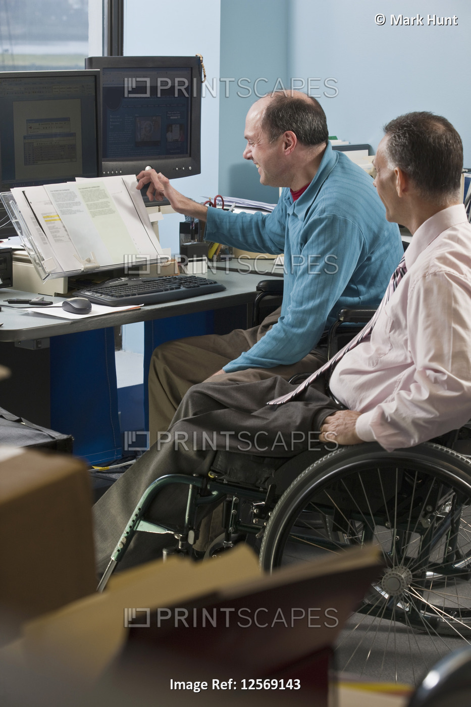 Two businessmen in an office, one with Friedreich's Ataxia and another with ...