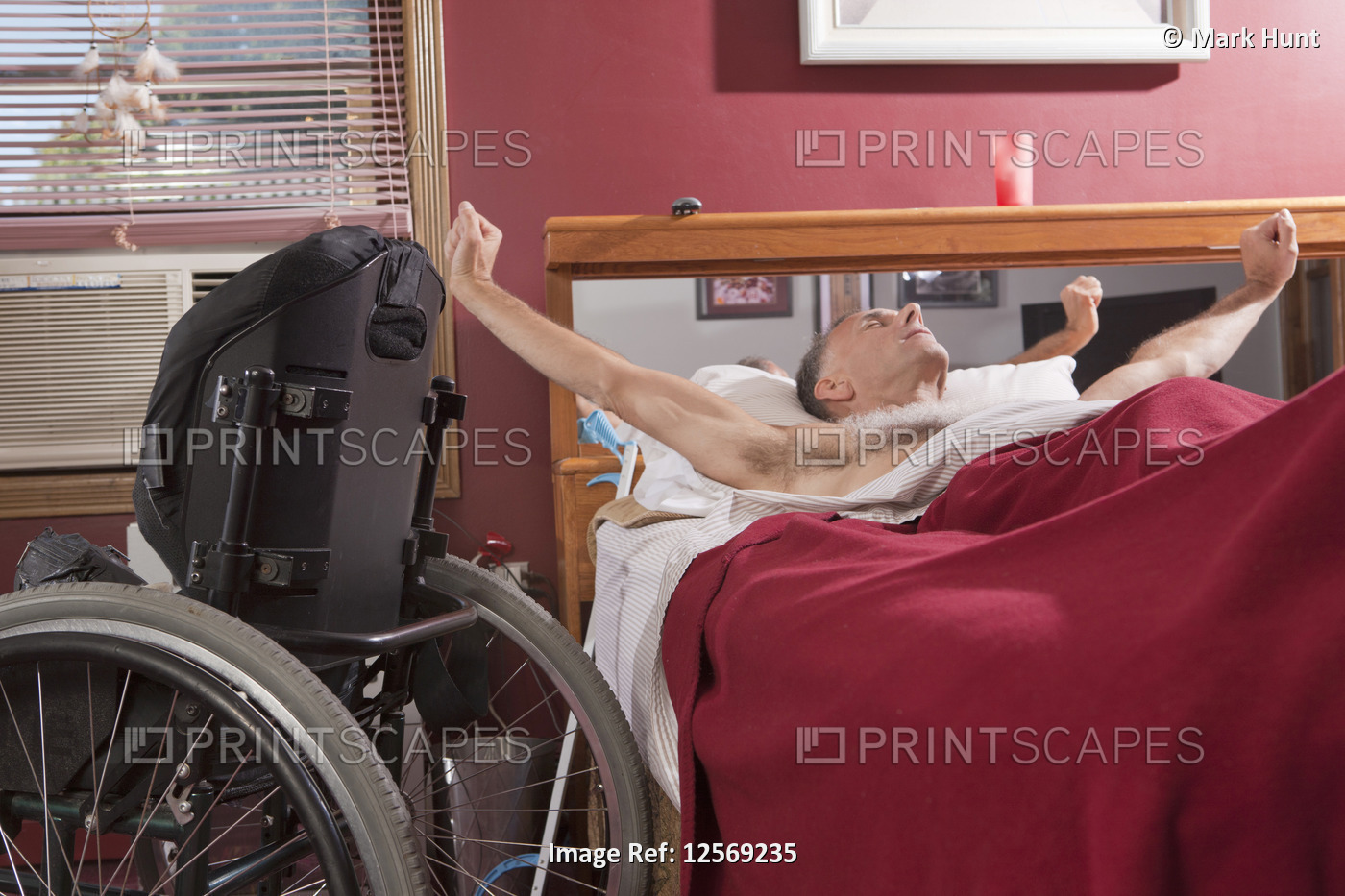 Man with spinal cord injury stretching on the bed