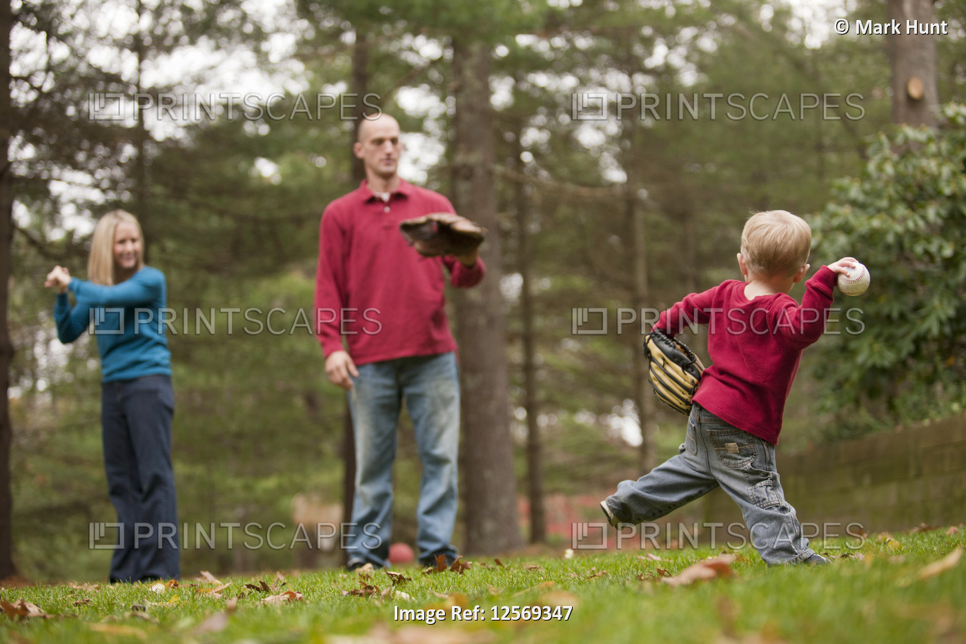 Boy playing baseball with his parents and using sign language to communicate