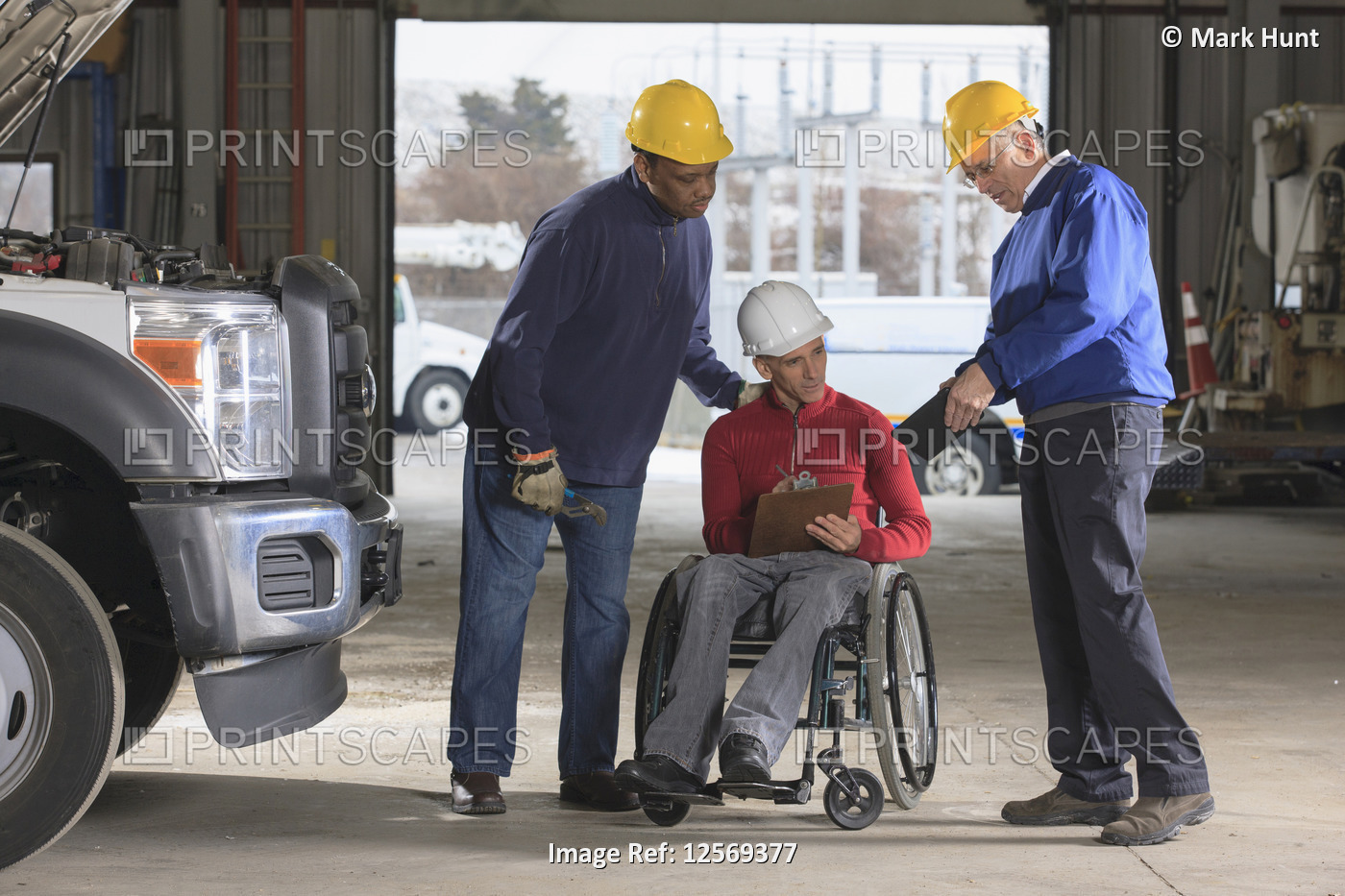 Power plant engineers one with spinal cord injury reviewing work logs in ...