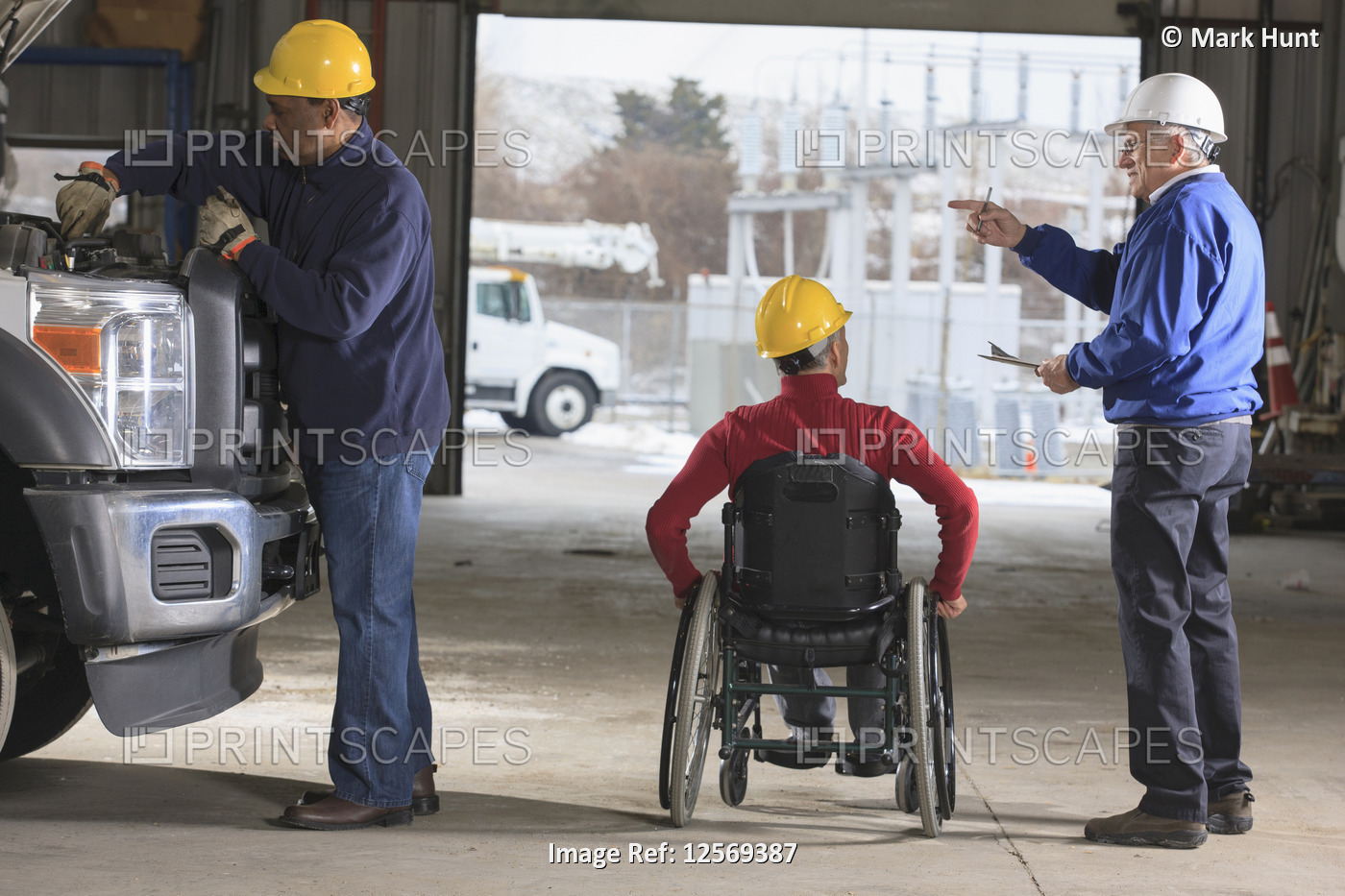 Supervisors one with spinal cord injury reviewing utility truck maintenance at ...