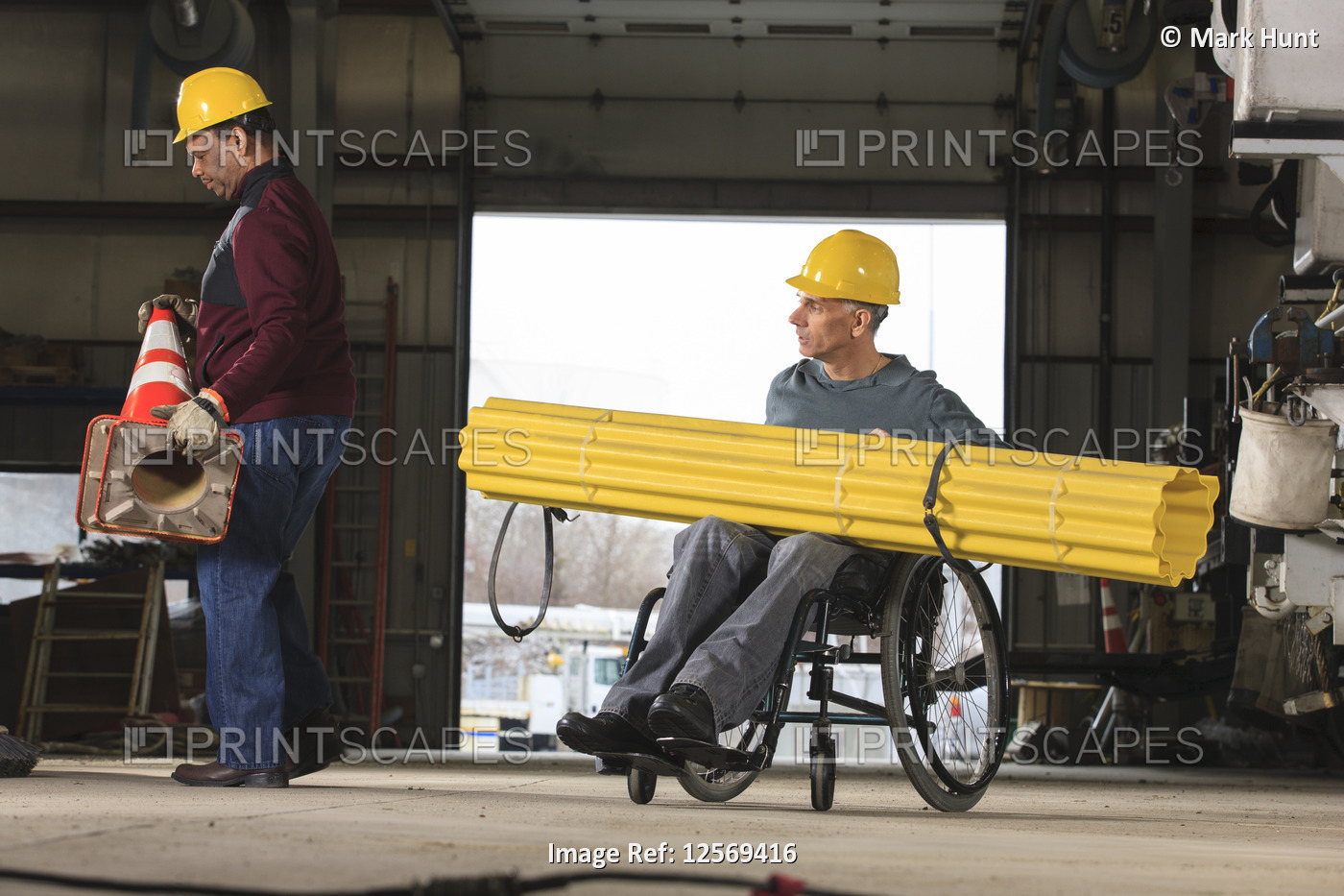 Maintenance supervisors one with spinal cord injury preparing to load shielding ...