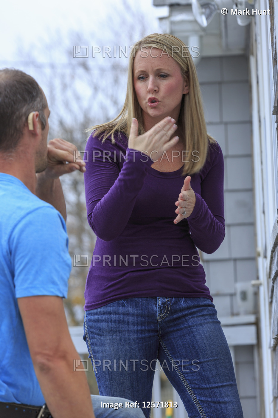Woman using sign language to communicate to a man