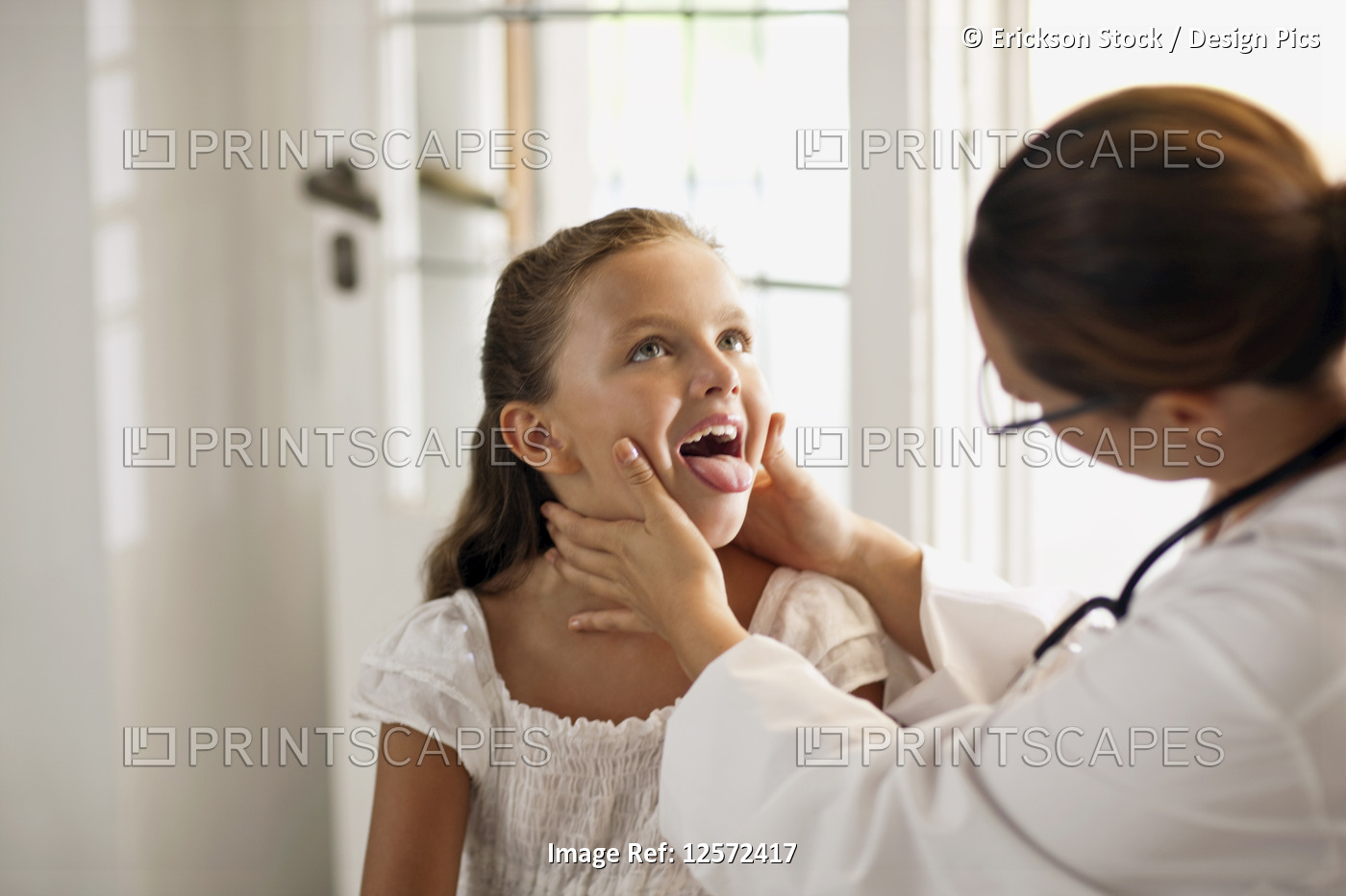Friendly gentle female doctor examining young patient.