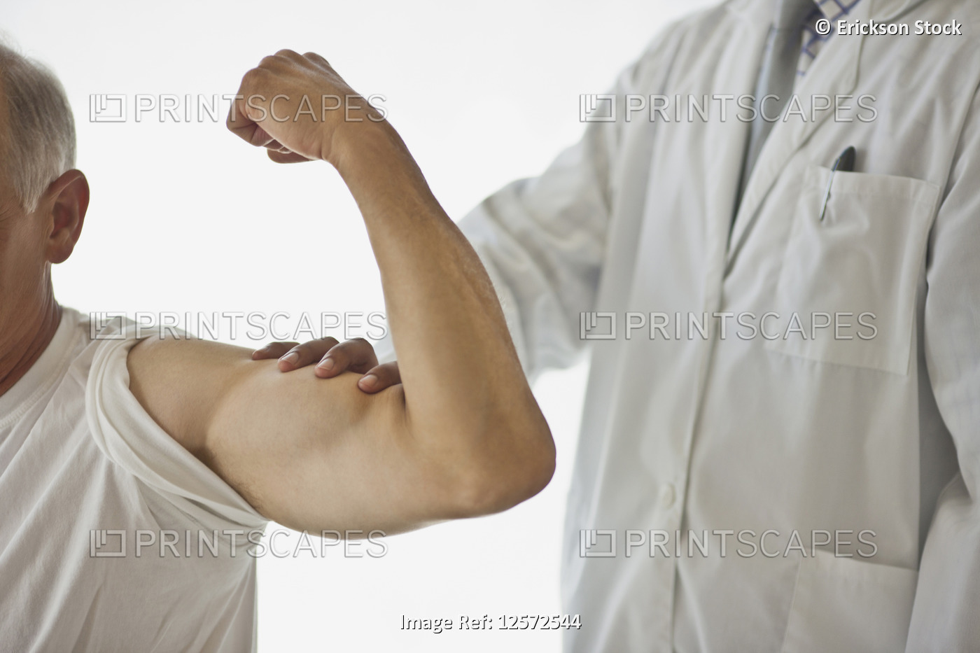 Doctor feeling a patient's flexed bicep muscle