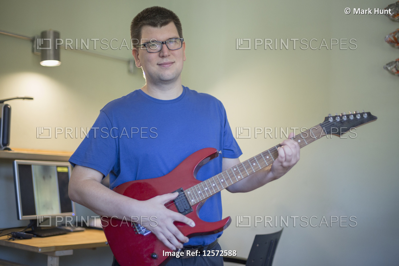 Man with Visual Impairment playing his guitar