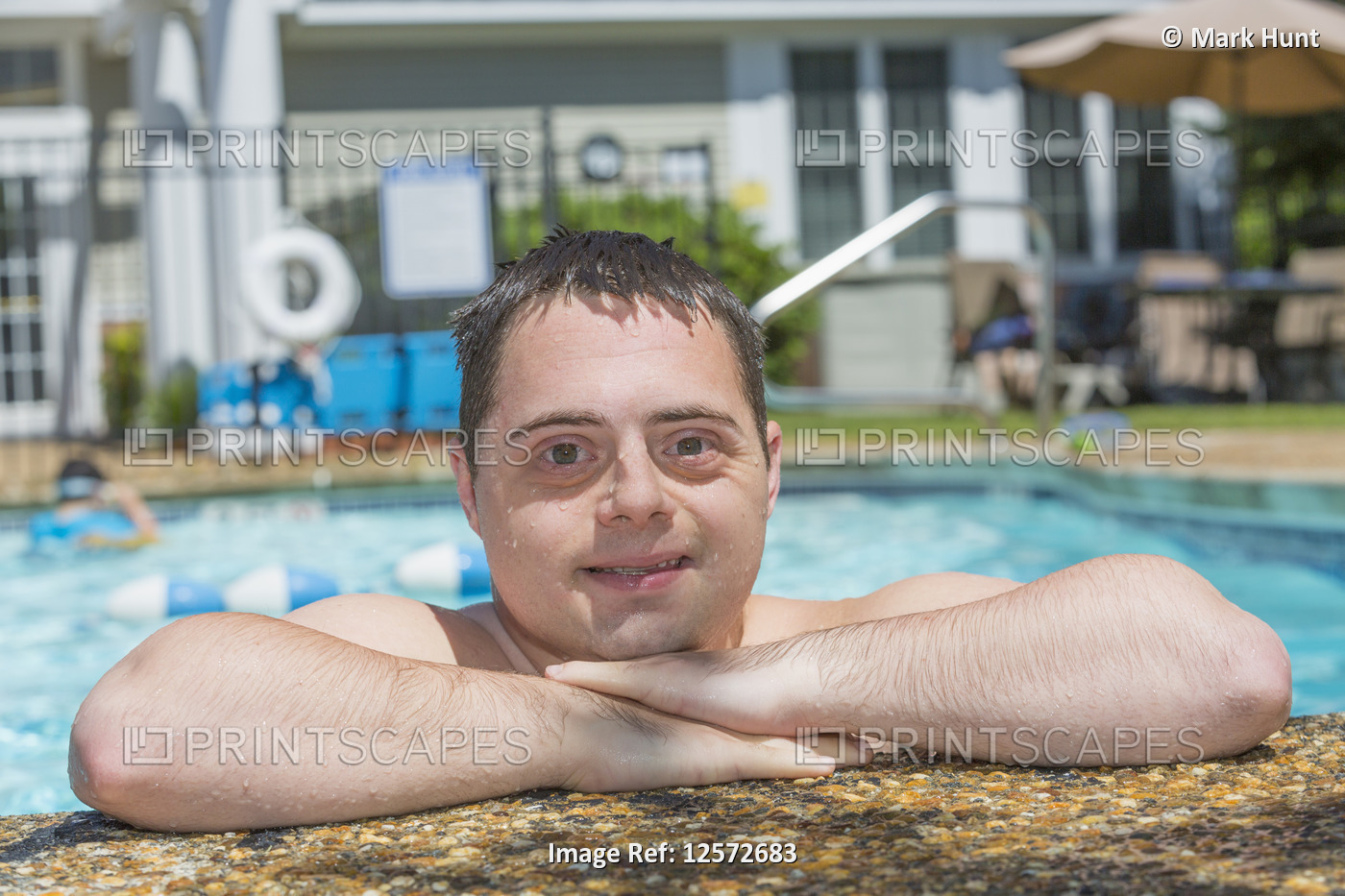 Man with Down Syndrome swimming in the pool