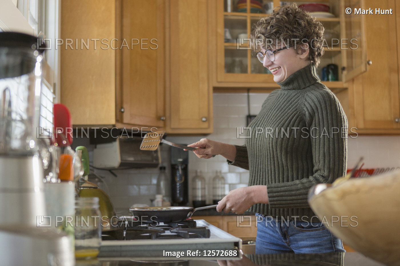 Woman with Sjogren-Larsson Syndrome cooking in kitchen