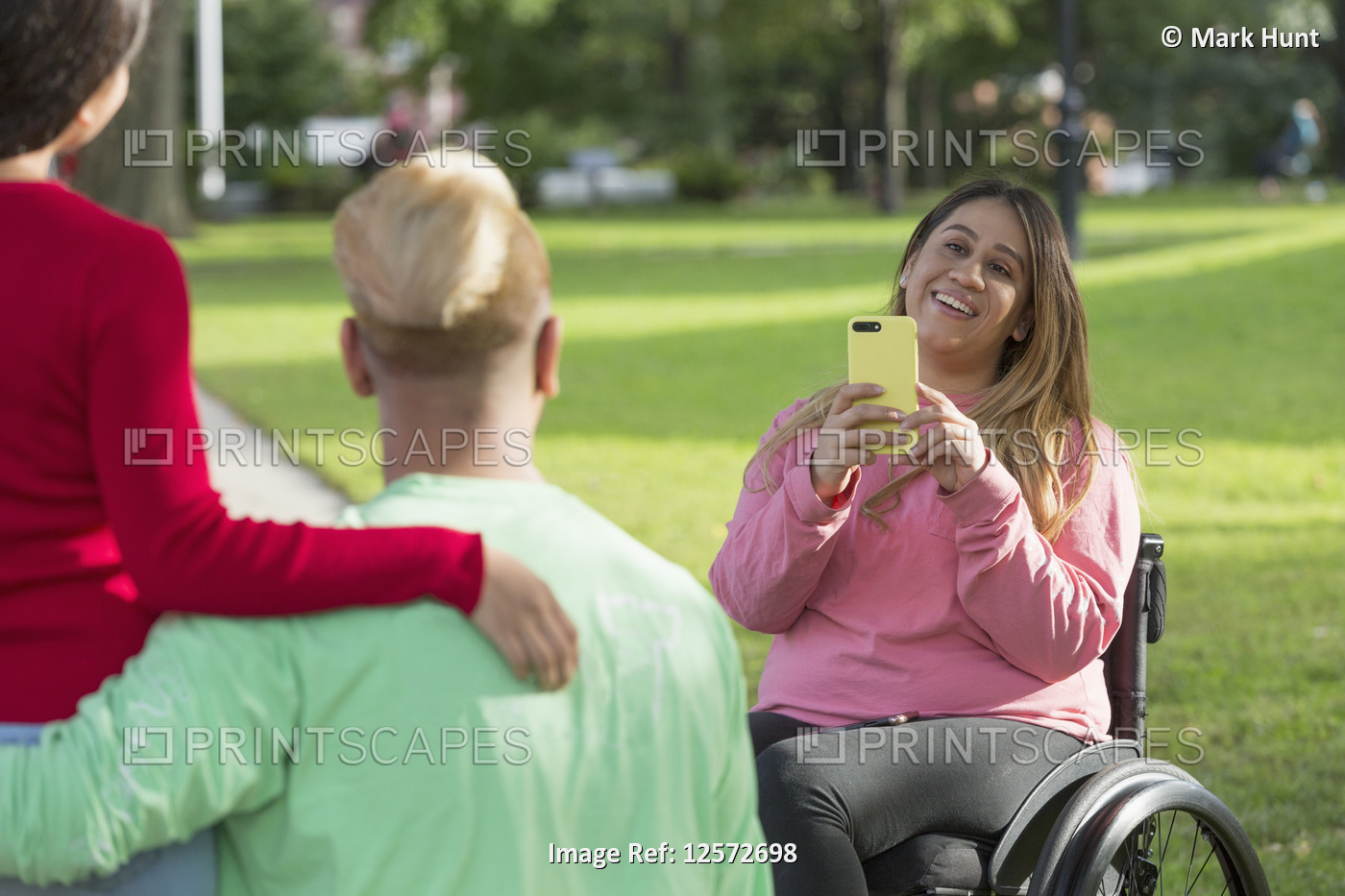 Woman with Spinal Cord Injury taking a picture of her friends