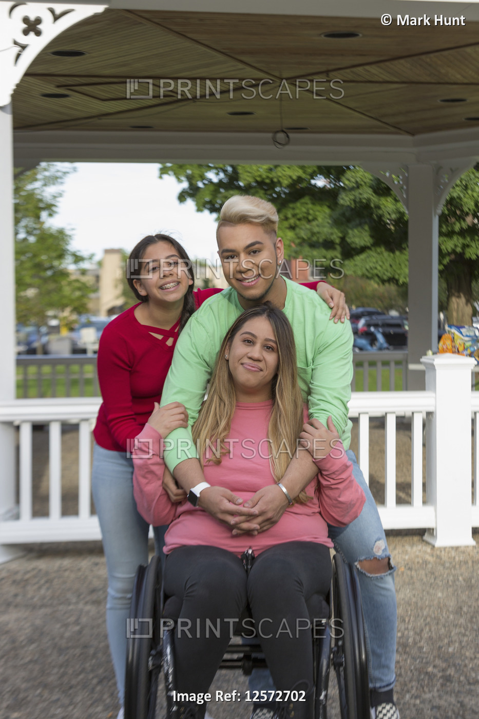 Portrait of three happy friends, one with a Spinal Cord Injury