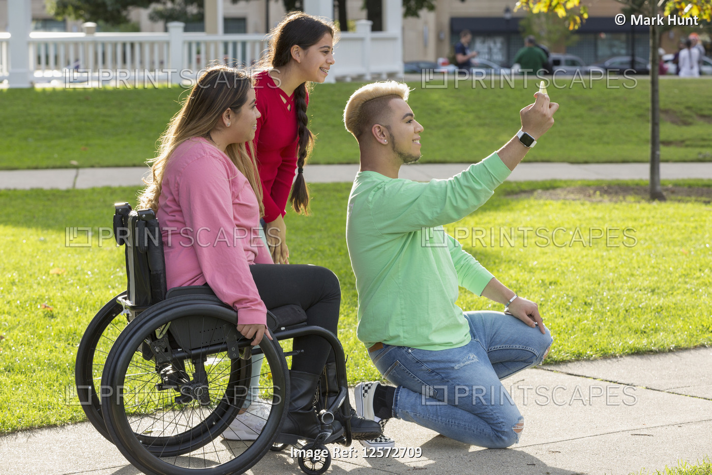 Three friends taking selfie, one with a Spinal Cord Injury