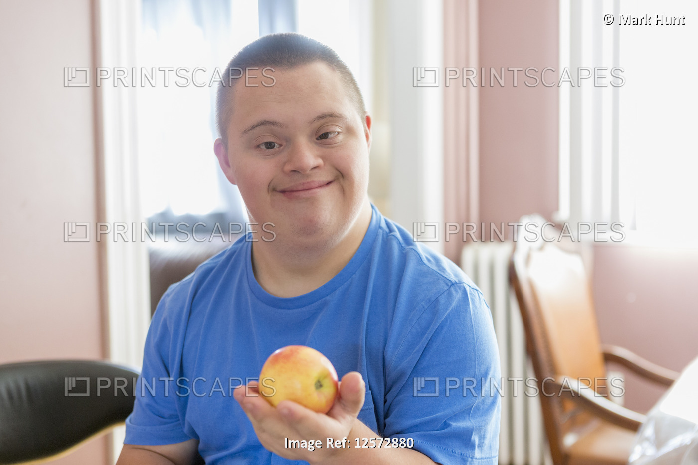 Teen with Down Syndrome holding fruit