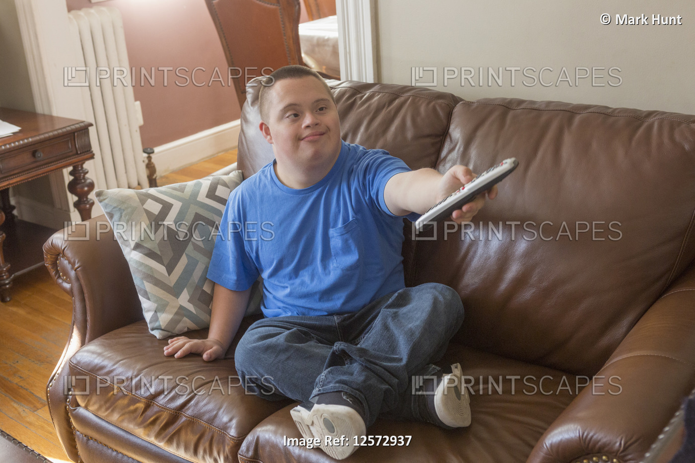 Teen with Down Syndrome with TV remote