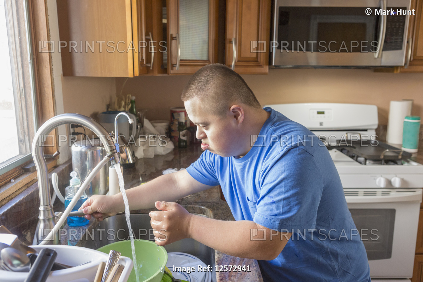 Teen with Down Syndrome doing dishes
