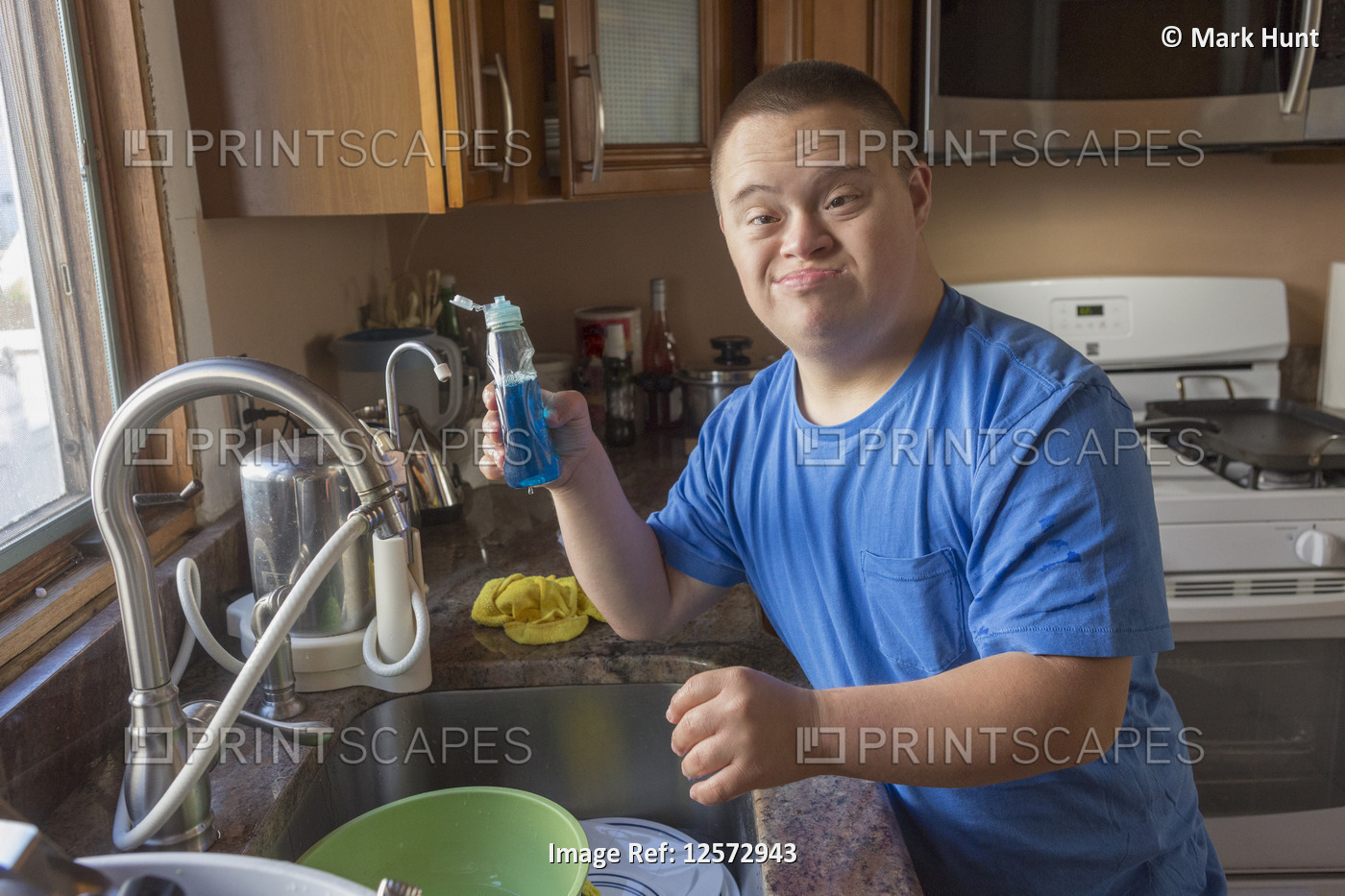 Teen with Down Syndrome doing dishes