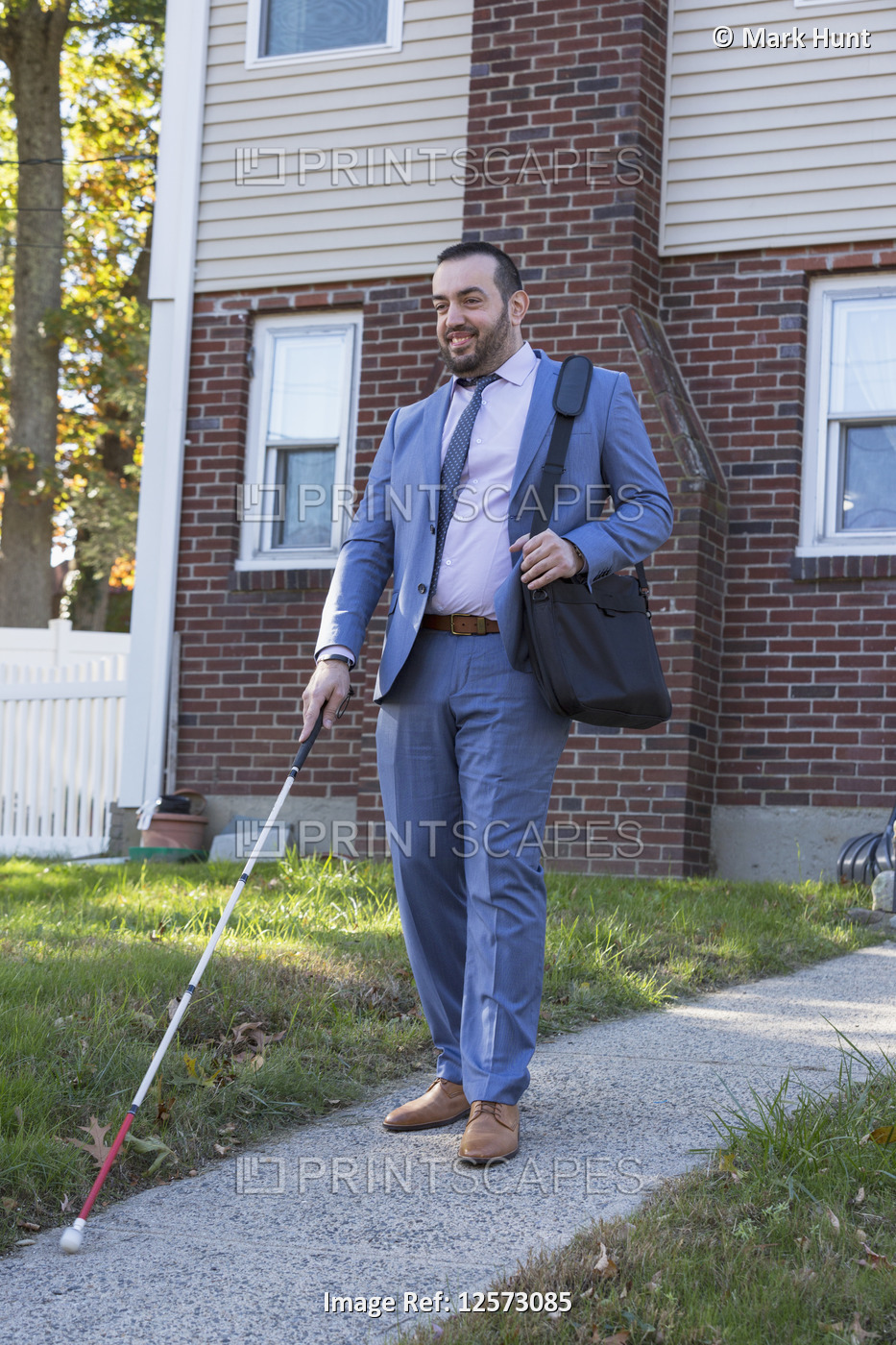 Businessman with Visual Impairment outside with his cane