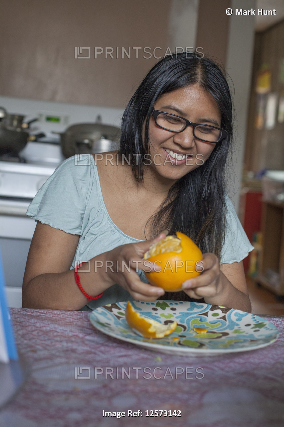 Woman with Visual Impairment peeling an orange