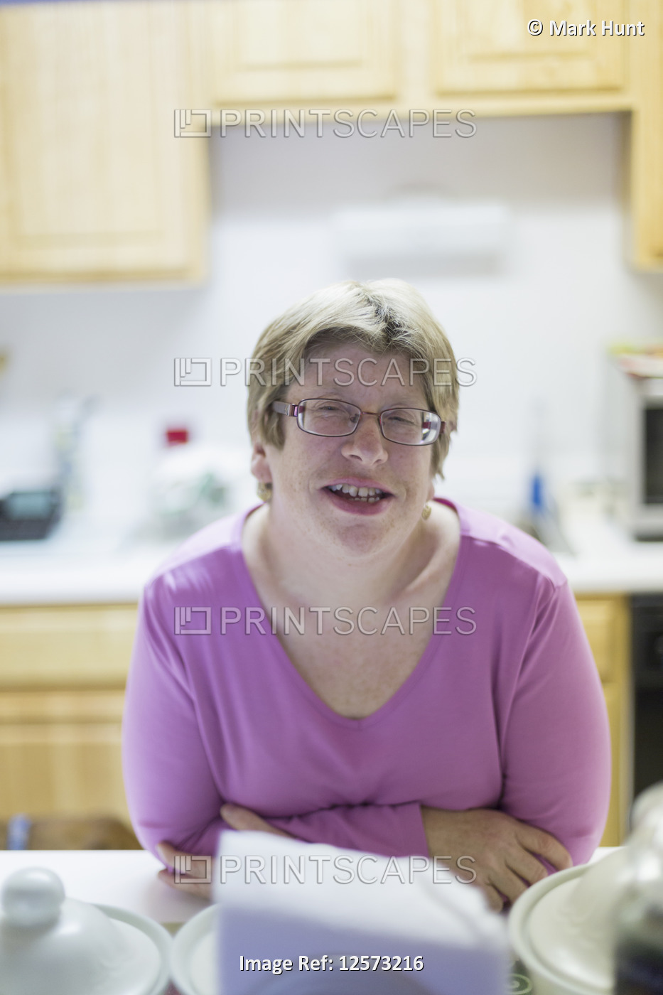 Woman with Autism smiling at dining table