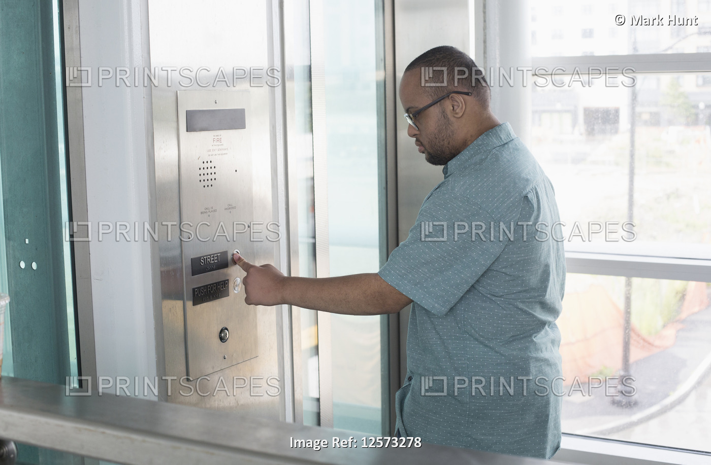 African American man who has Down Syndrome using an elevator