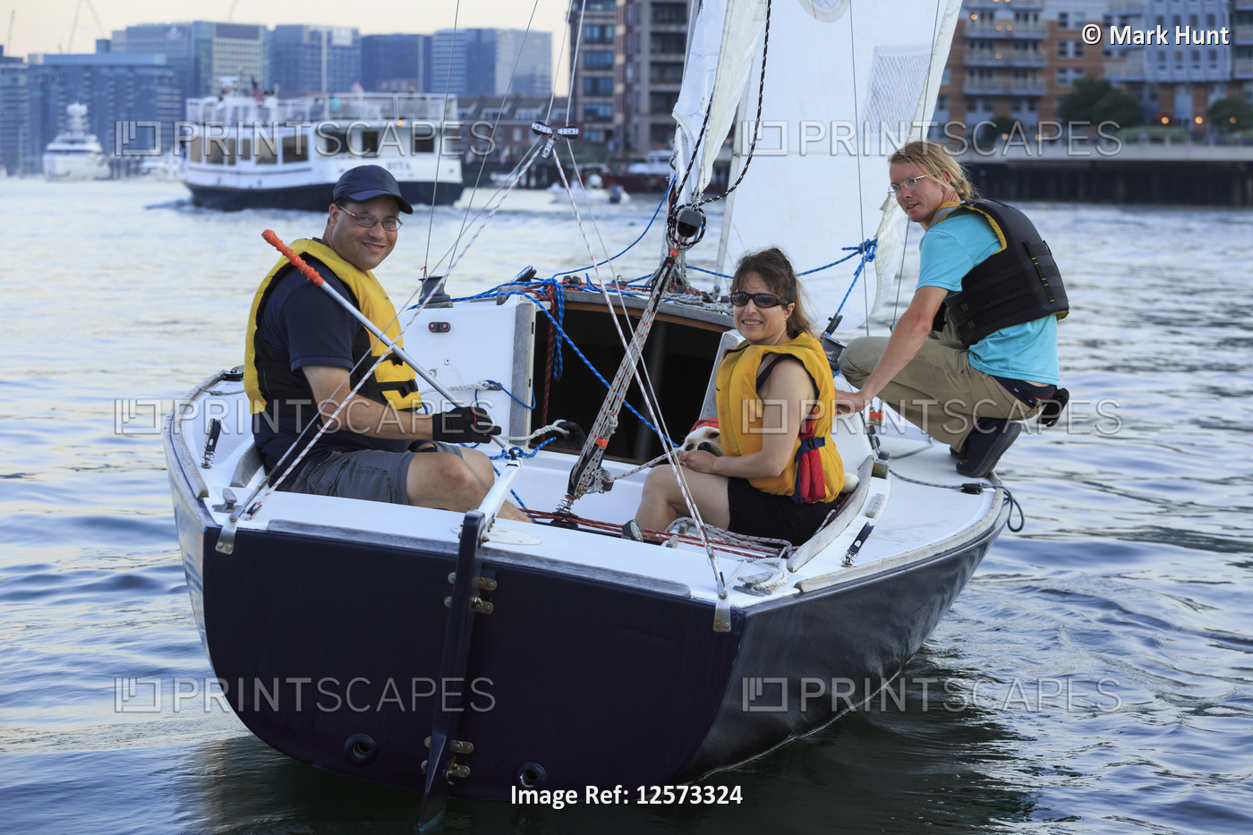 Coach and couple with visual impairment and service dog on boat