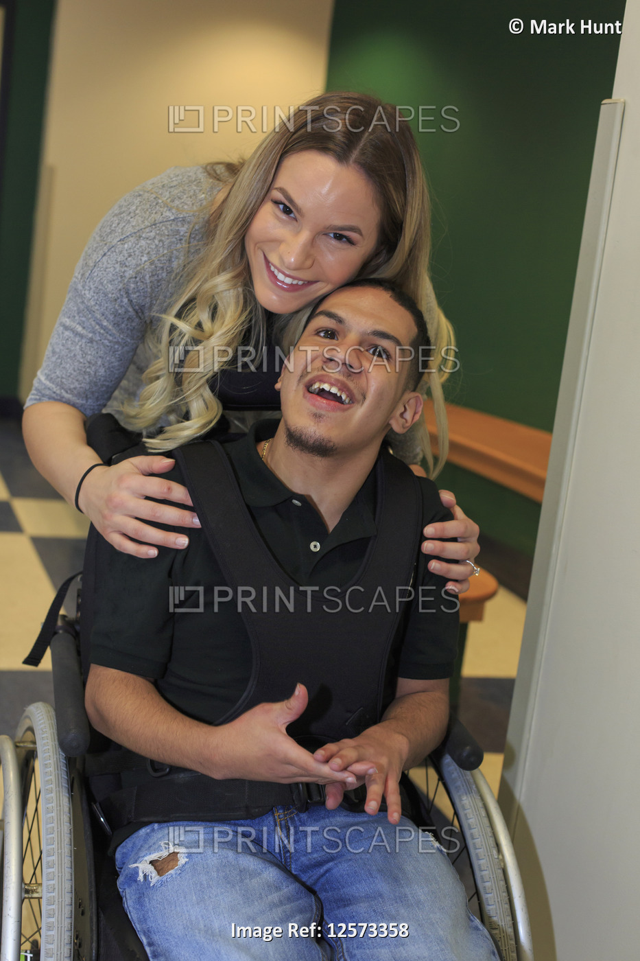 Boy with Spastic Quadriplegic Cerebral Palsy and teacher in the school hallway
