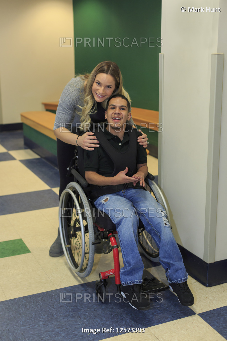 Boy with Spastic Quadriplegic Cerebral Palsy and teacher in the school hallway
