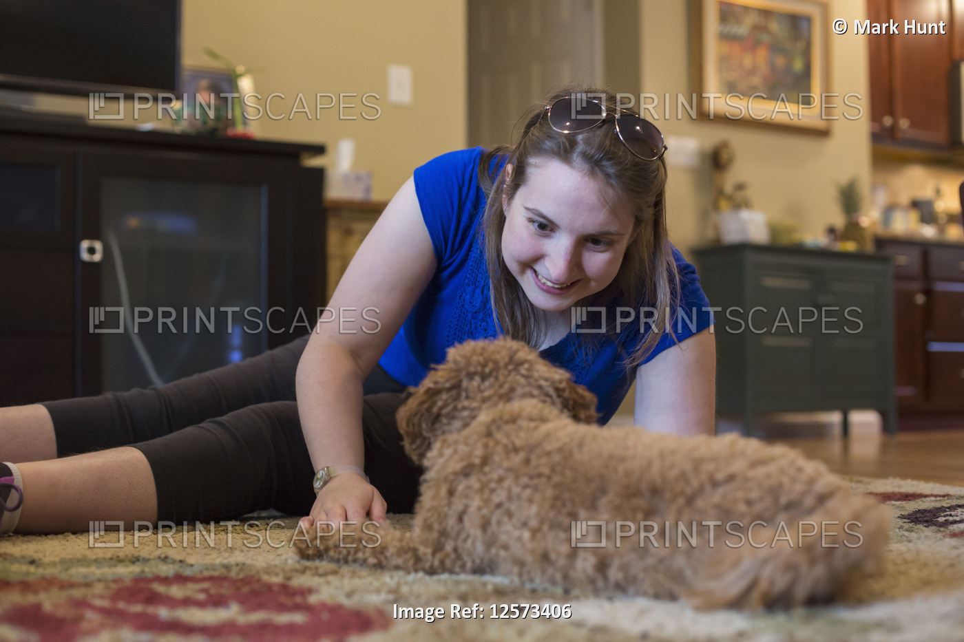 Young Woman with Cerebral Palsy playing with dog at home