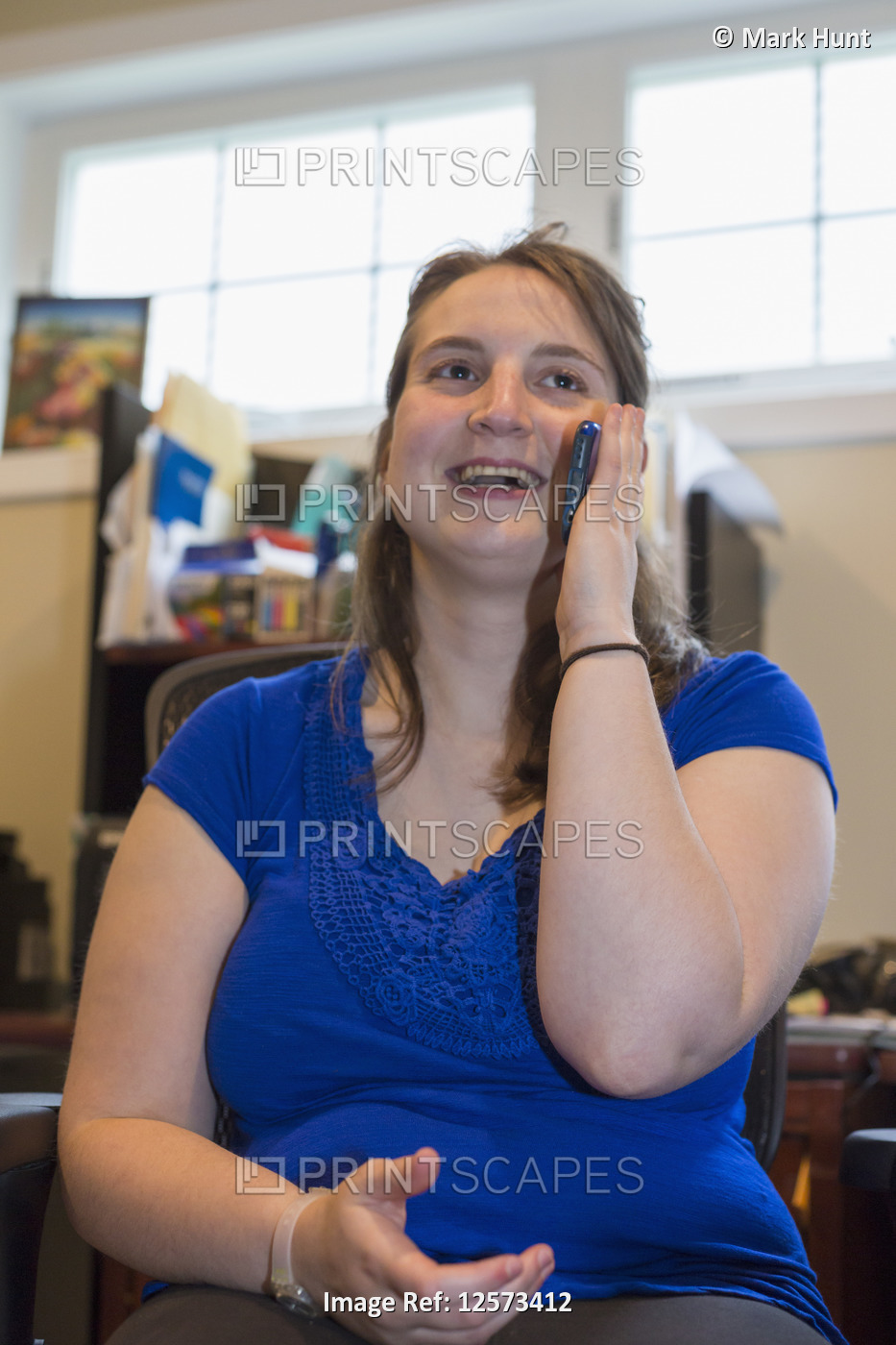 Young Woman with Cerebral Palsy talking on her cell phone at home