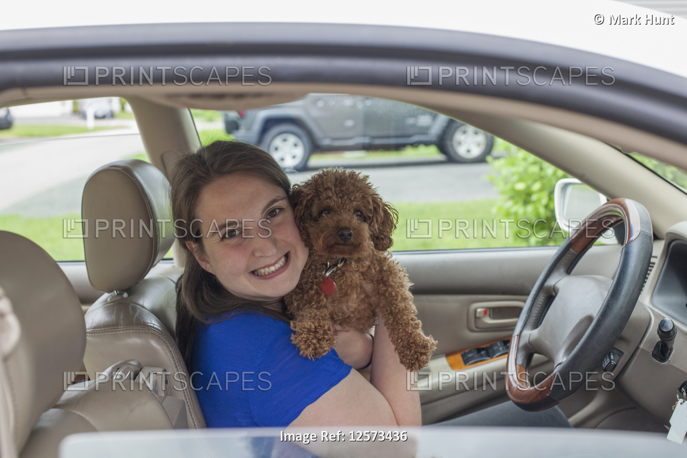 Young Woman with Cerebral Palsy holding her dog in the car