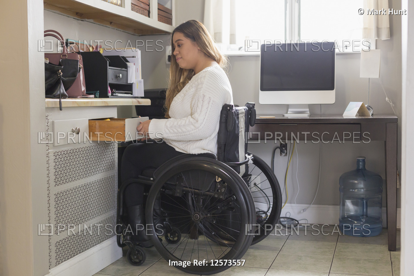 Woman with Spinal Cord Injury arranging things in her room