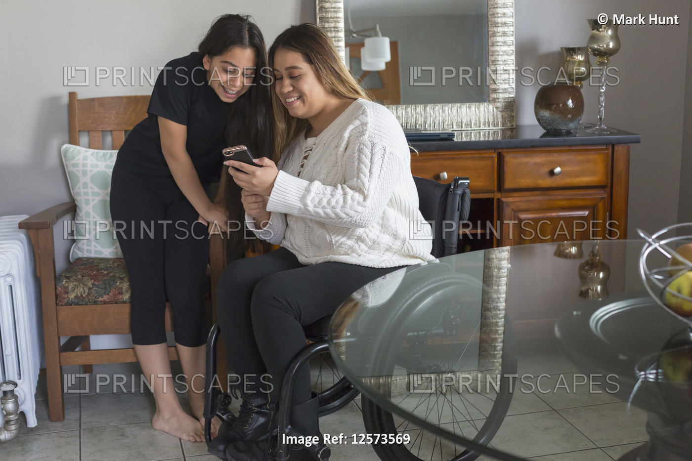 Woman who has Spinal Cord Injury reading a text with her sister