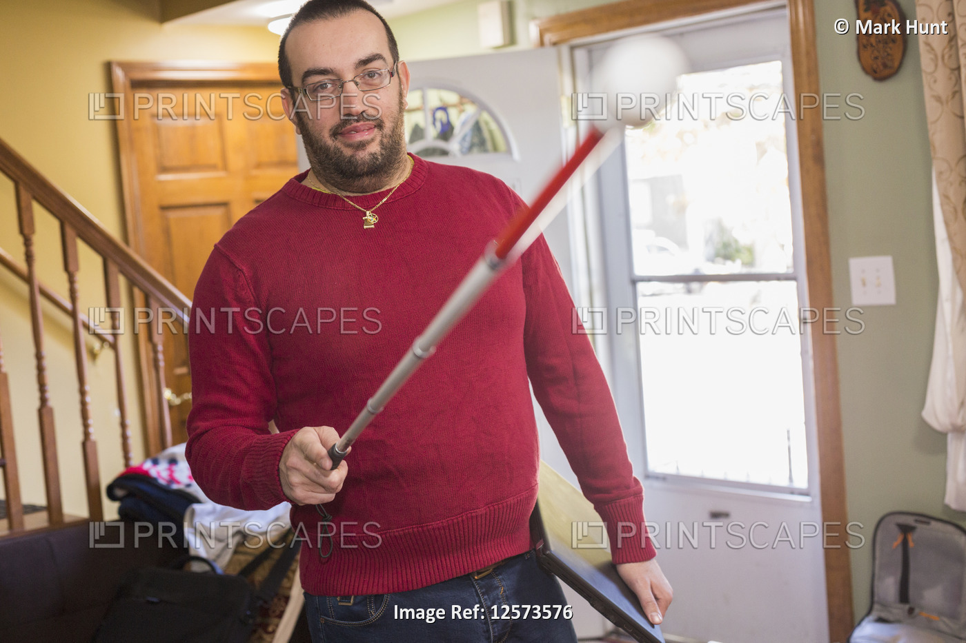 Man who has Visual Impairment with his cane at home