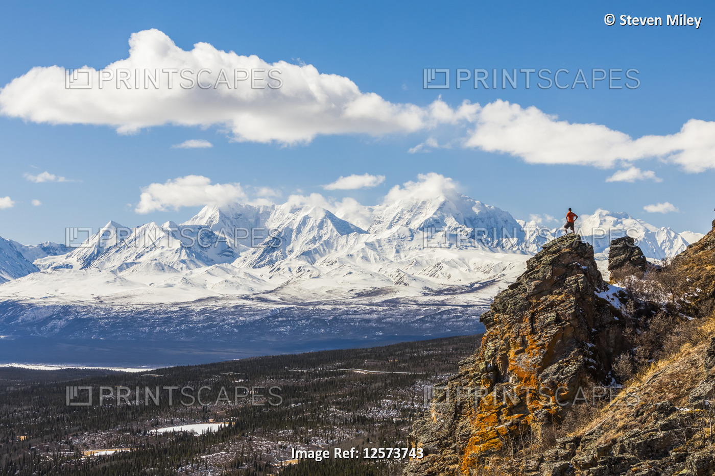 A hiker stands atop a rock outcropping on Donnelly Dome while taking in the ...