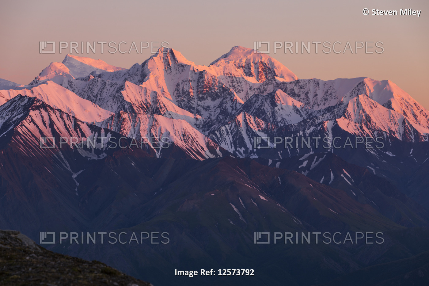 Sunrise alpenglow on the Eastern Alaska Range, including (from left to right) ...