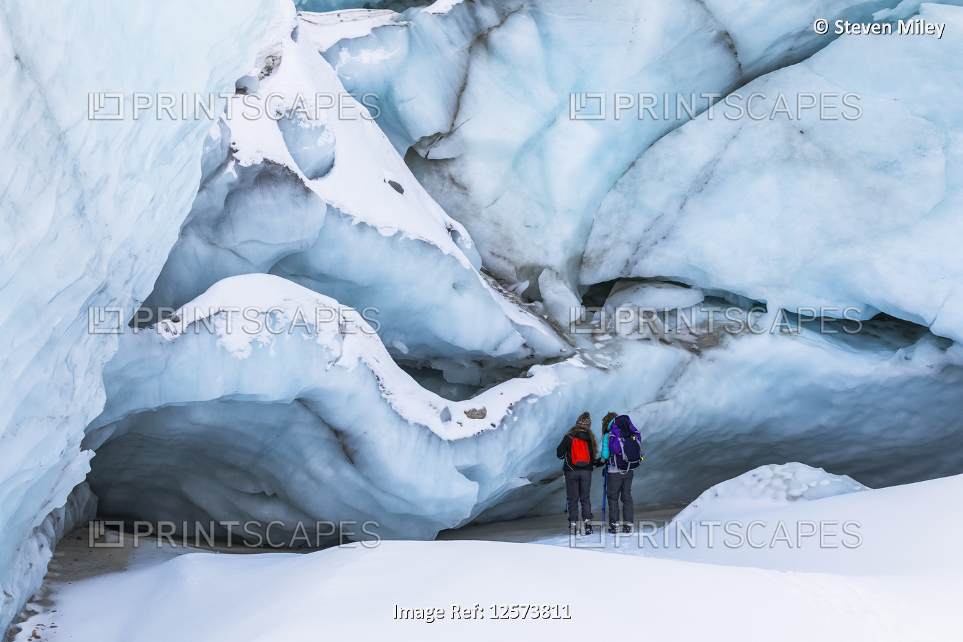 Two winter hikers examine the ice of Black Rapids Glacier; Alaska, United ...