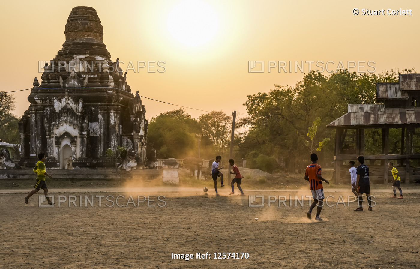 Boys playing football at sunset; Bagan, Mandalay Region, Myanmar