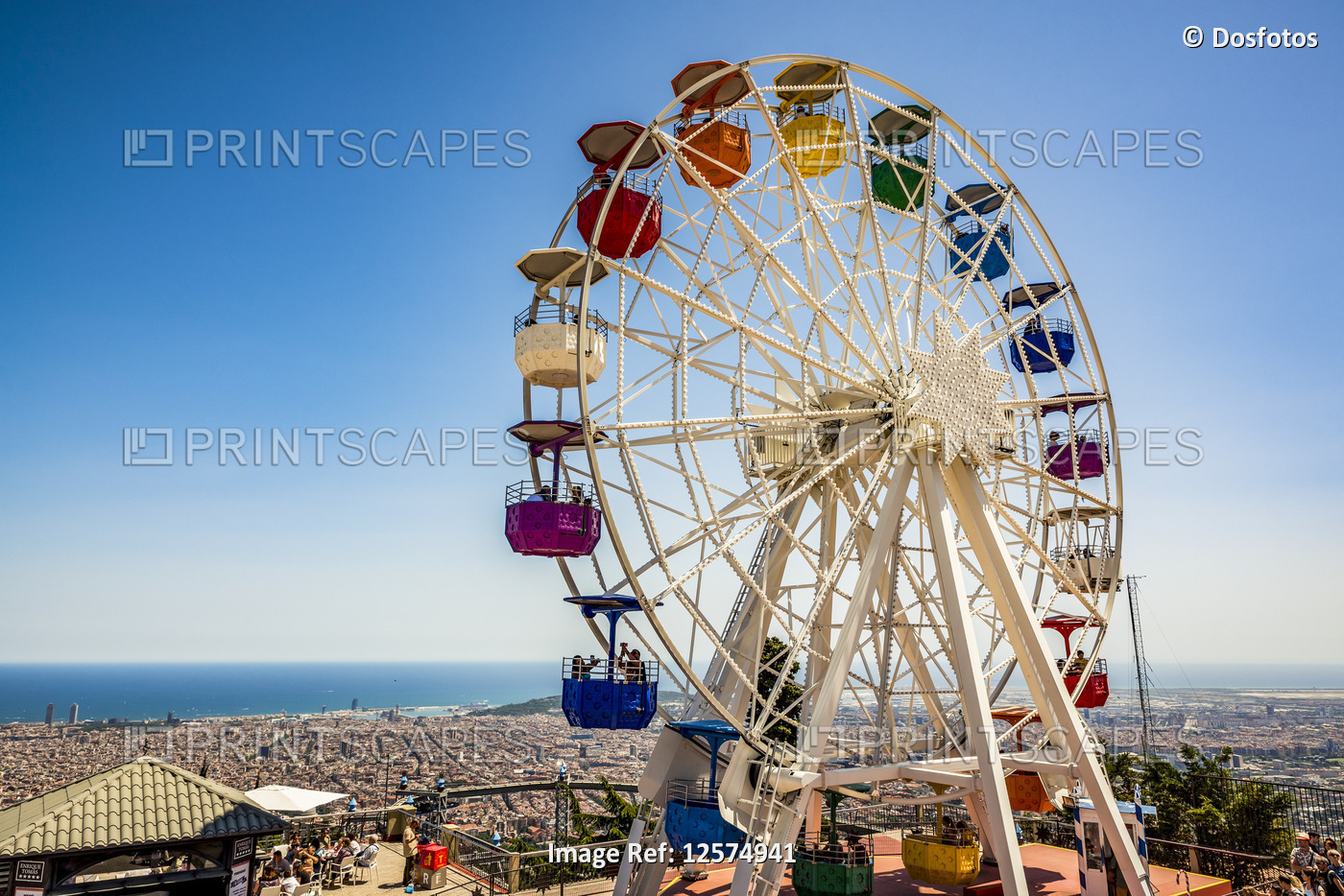 Amusement park with a colourful ferris wheel on Mount Tibidabo and a view of ...