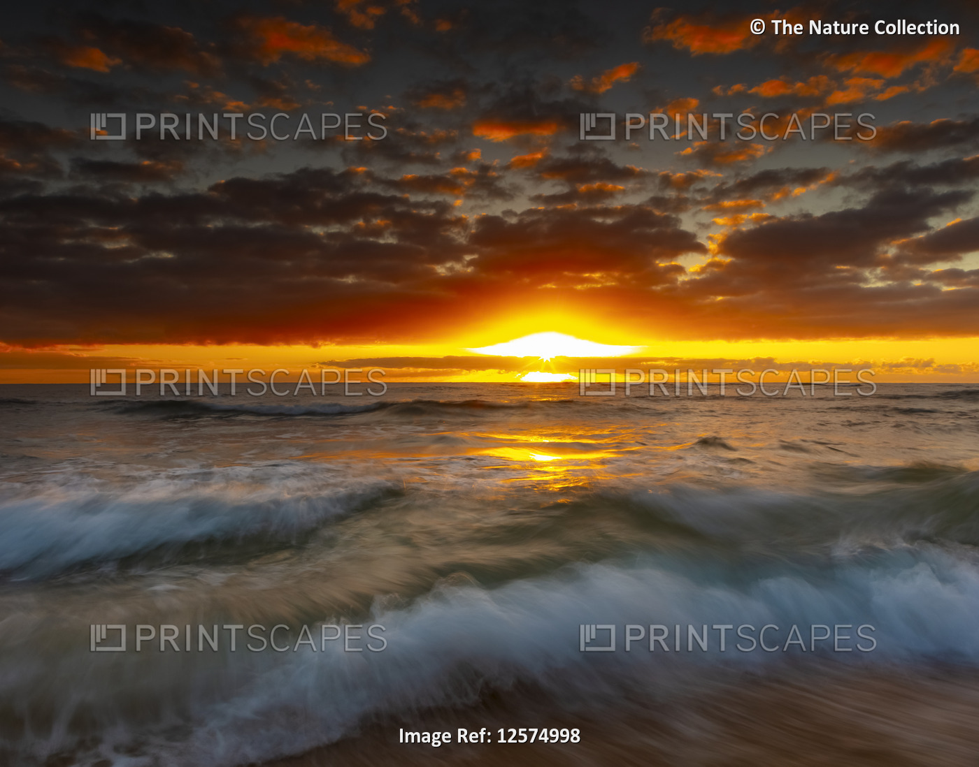 Bright, golden sunrise over beach and ocean; Kauai, Hawaii, United States of ...