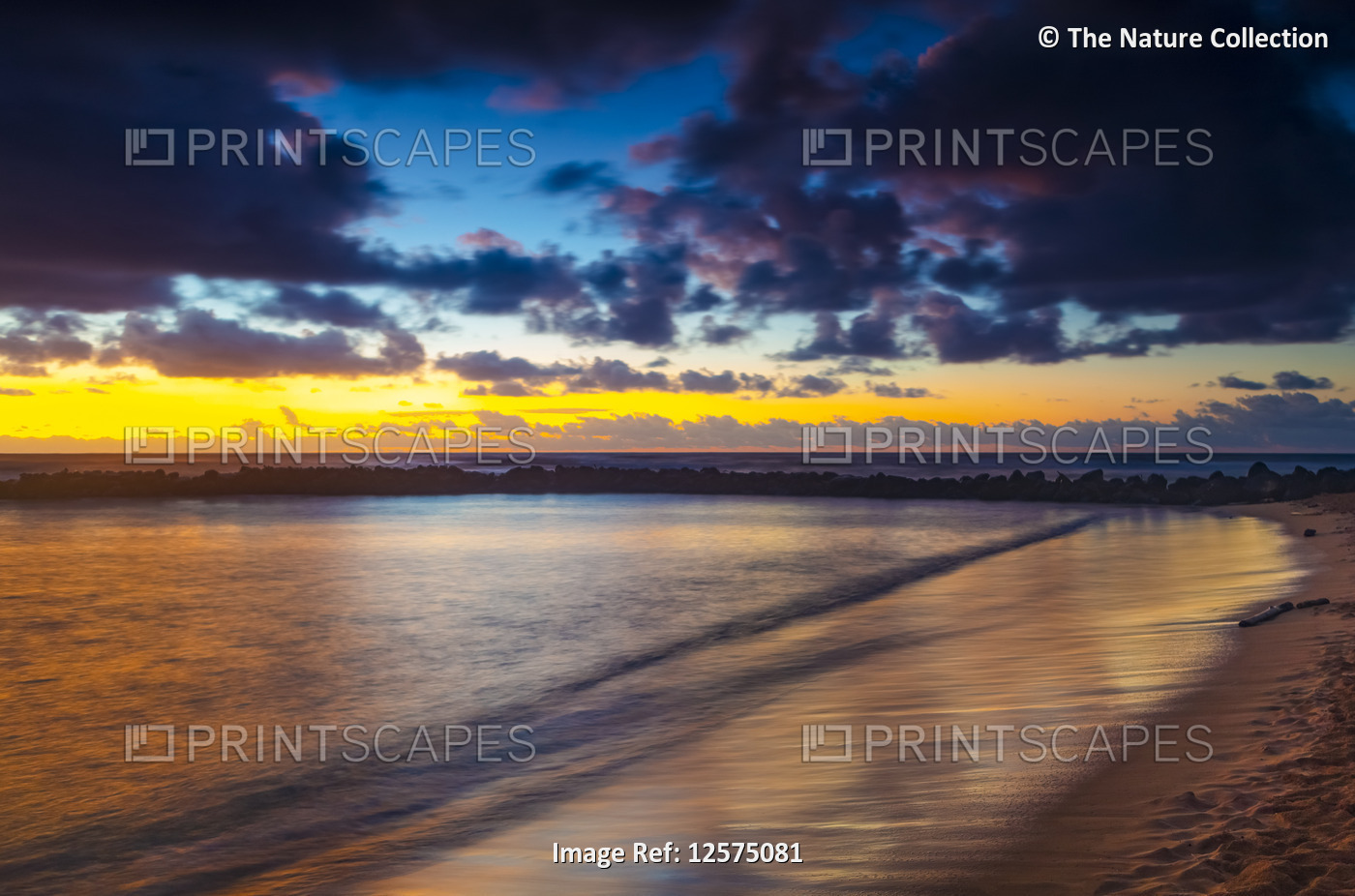 Dramatic sunrise over Lydgate Park, breakwater and the ocean from the coast of ...