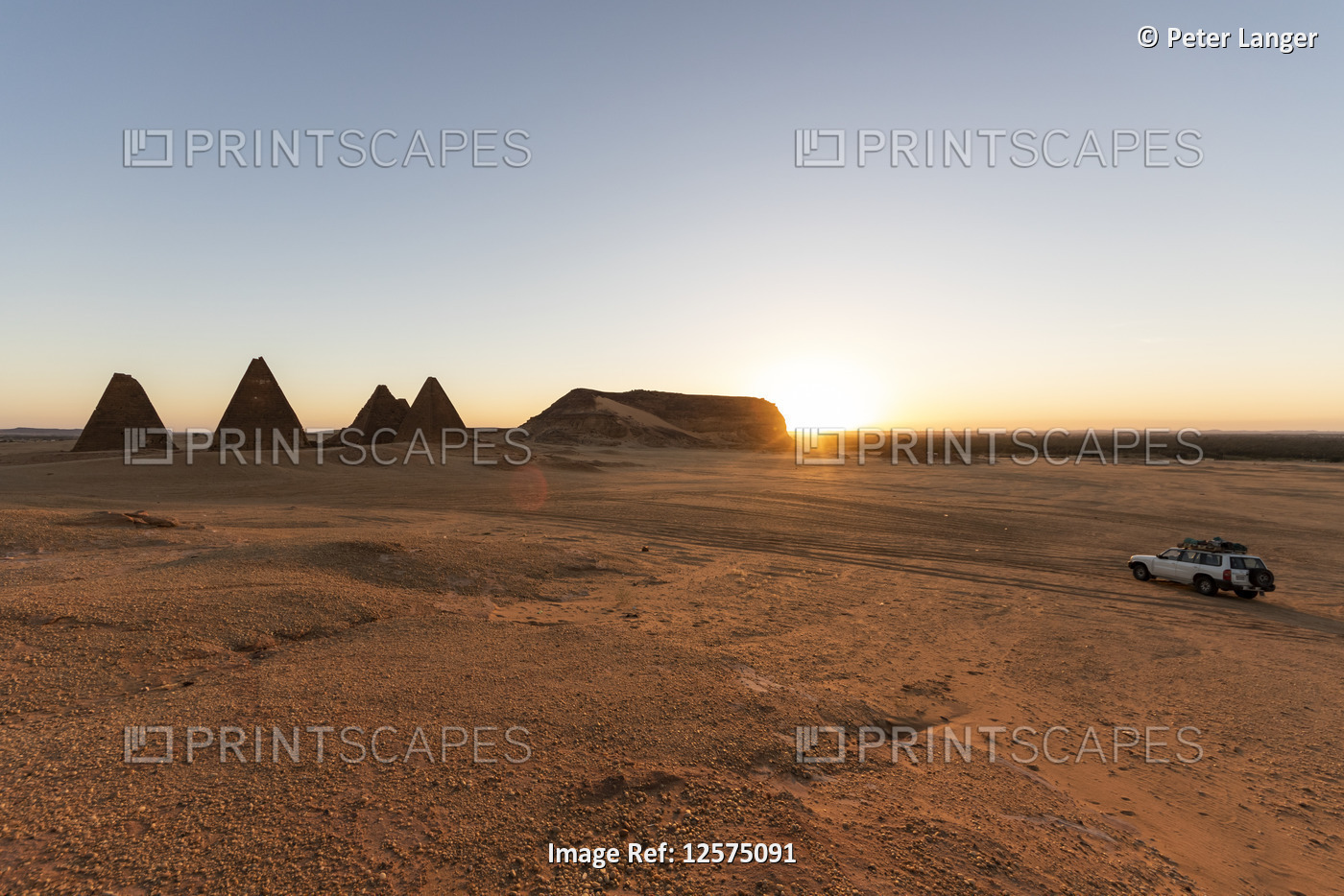 Field of Kushite royal pyramids and Mount Jebel Barkal at sunrise; Karima, ...