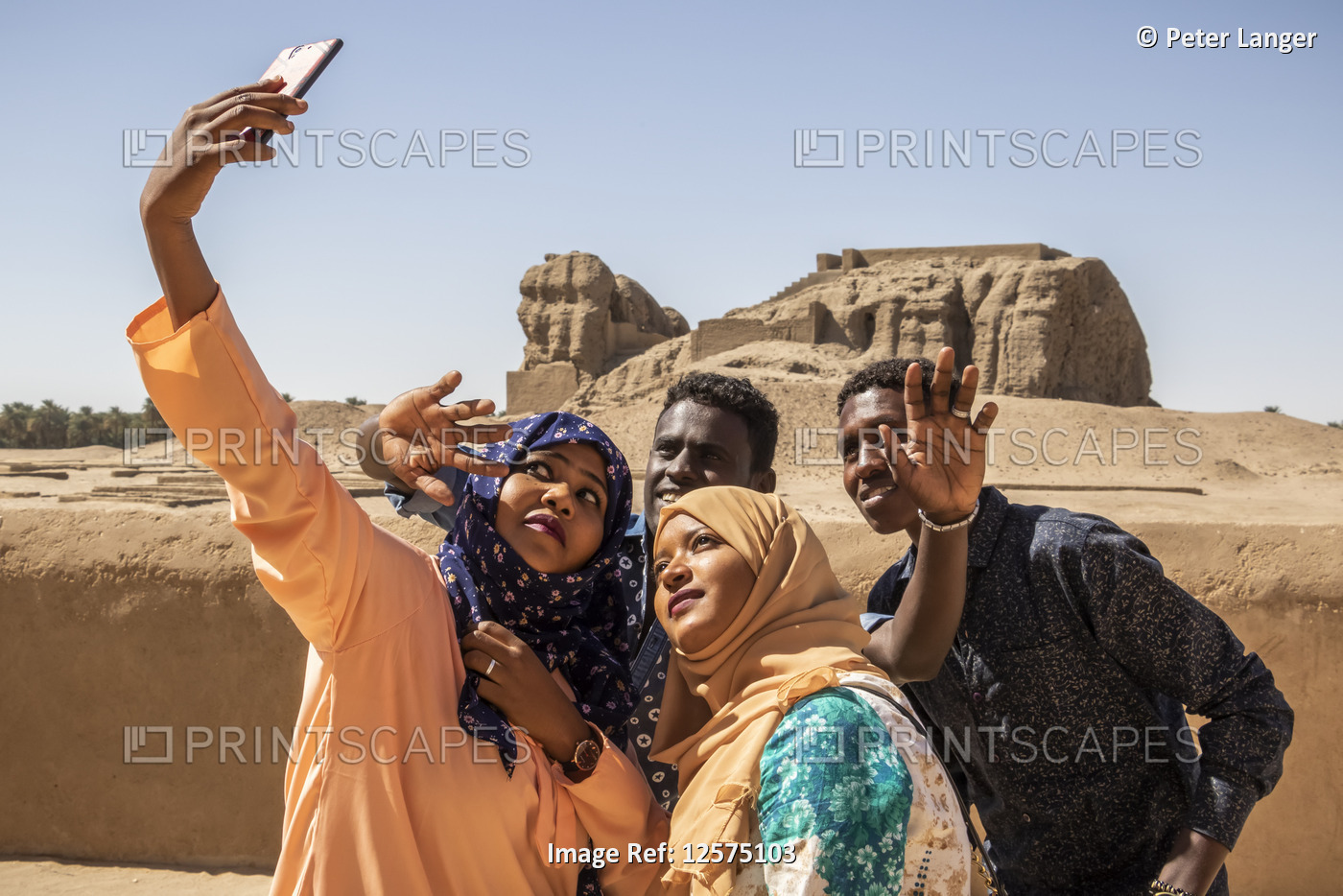 Sudanese students taking a self-portrait with a smart phone; Kerma, Northern ...
