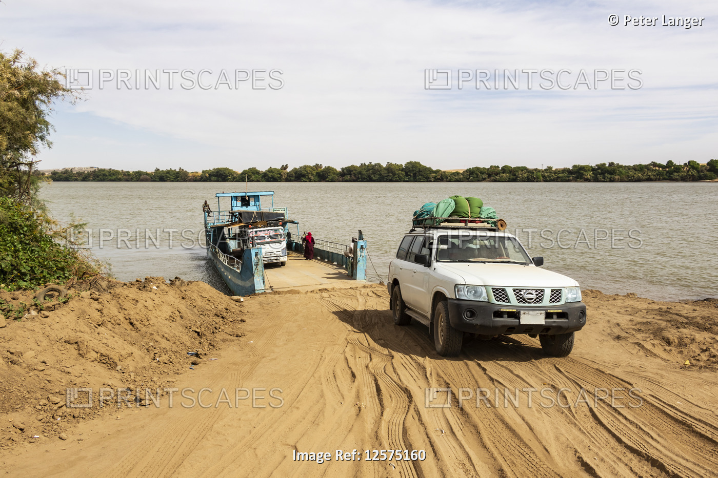 Four-wheel drive Toyota Land Cruiser exiting a ferry over the River Nile; ...